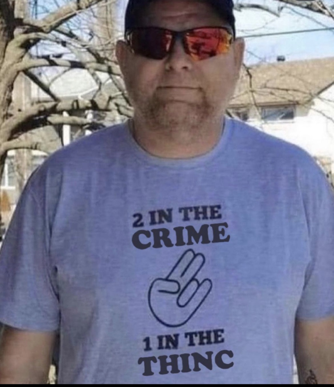 man wearing shirt that says “two in the CRIME, one in the THINC”